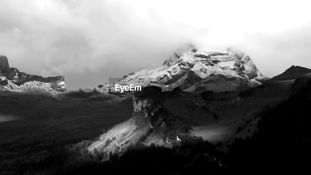 Scenic view of snow mountains against sky