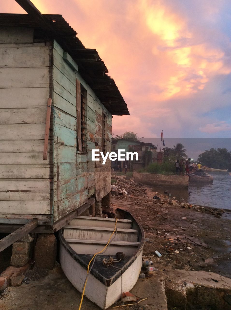 Abandoned boat by cottage