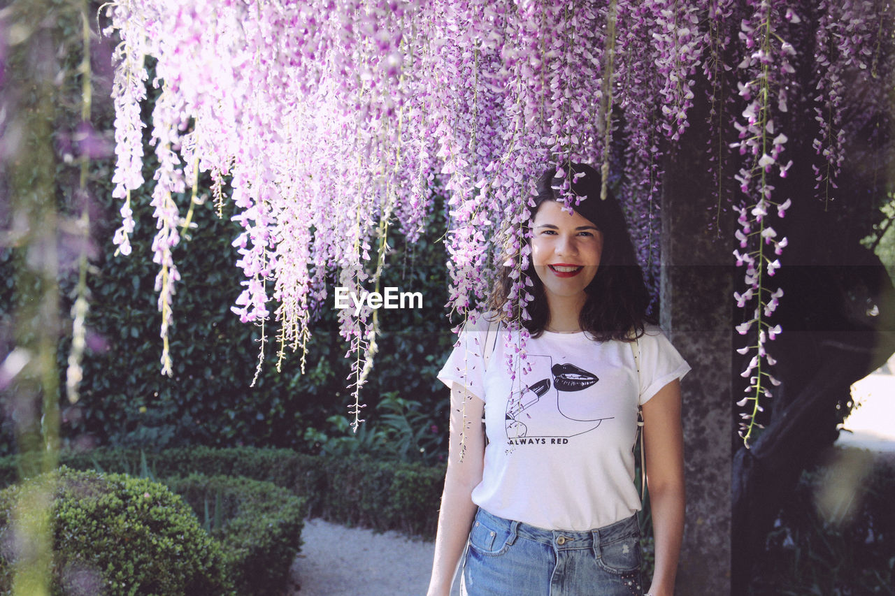 Portrait of smiling young woman standing outdoors