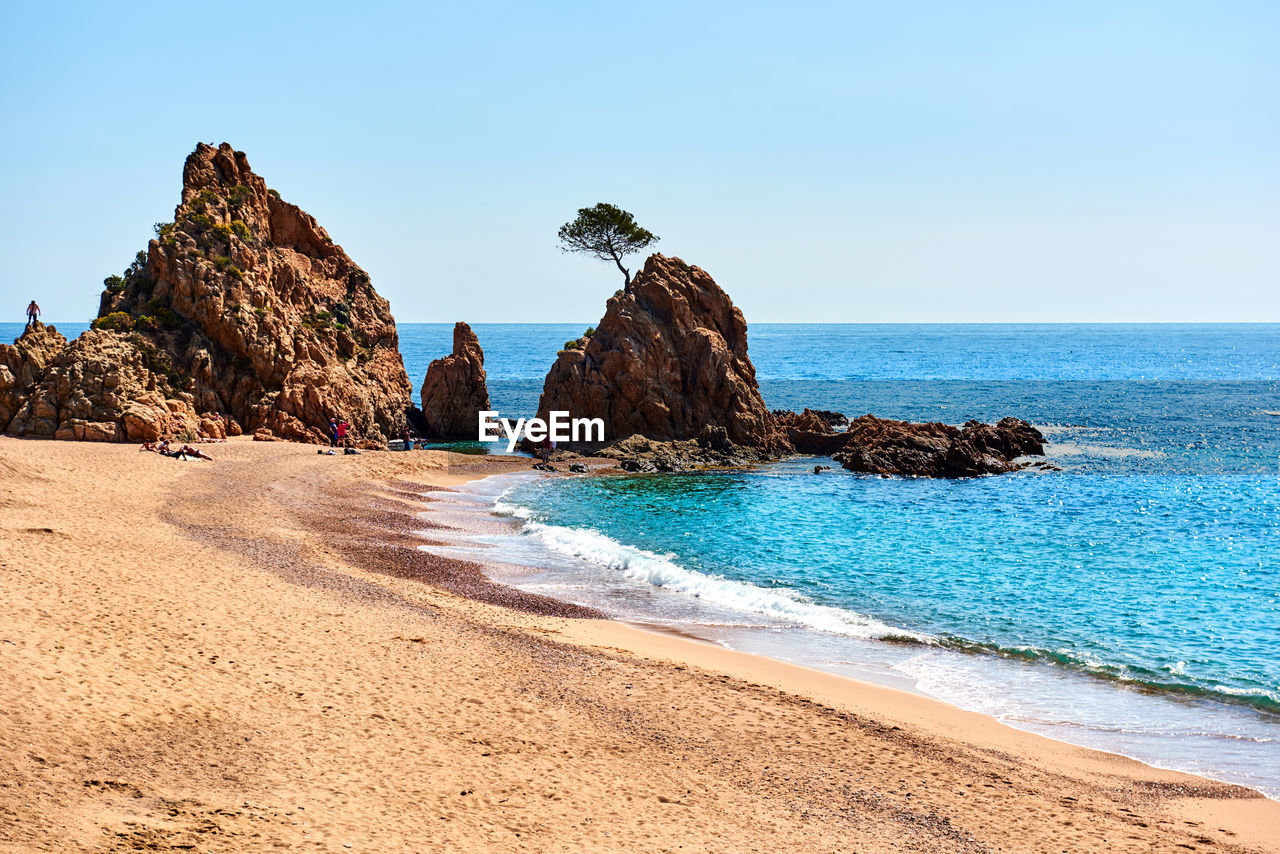 Scenic view of beach against clear sky