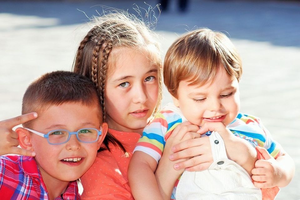 SIBLINGS PLAYING WITH SON