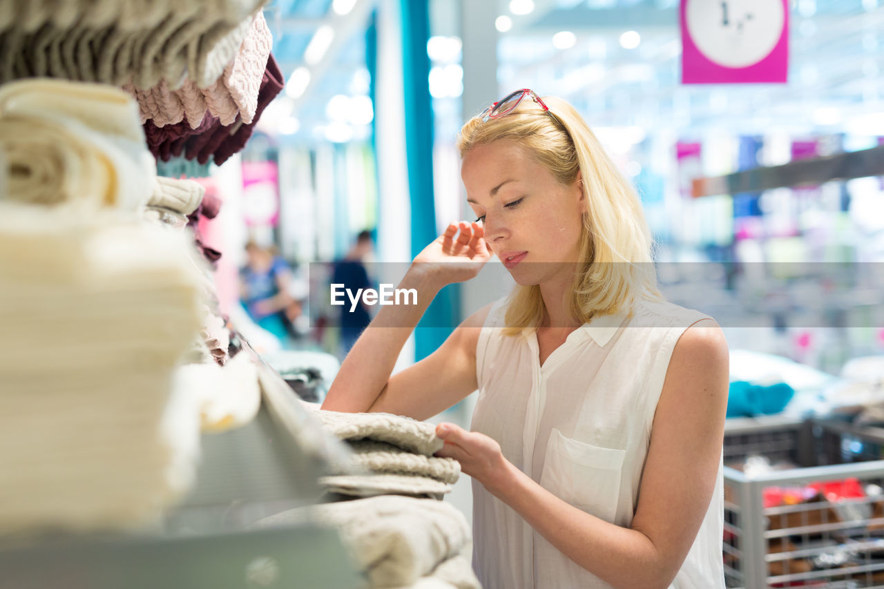 Mid adult woman standing at departmental store