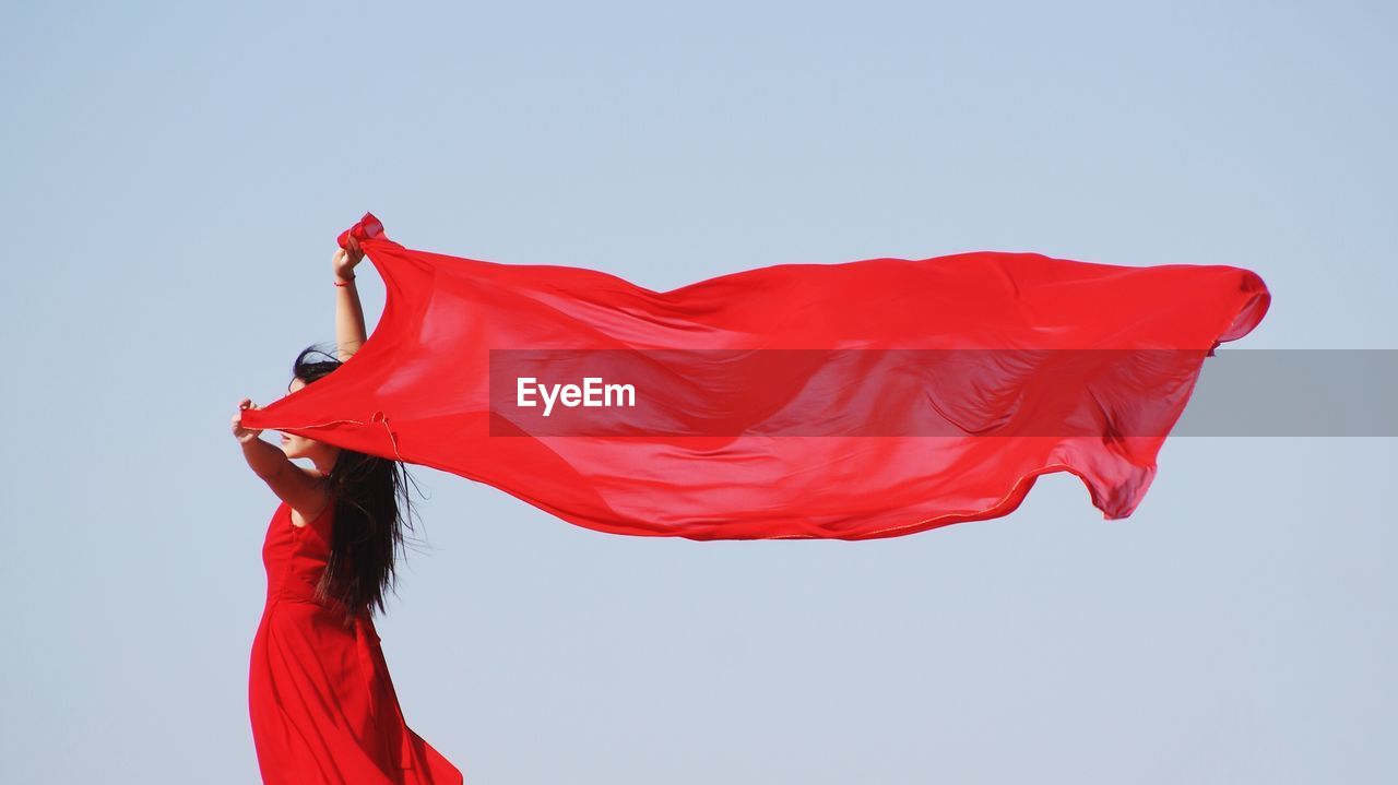 LOW ANGLE VIEW OF RED UMBRELLA AGAINST SKY