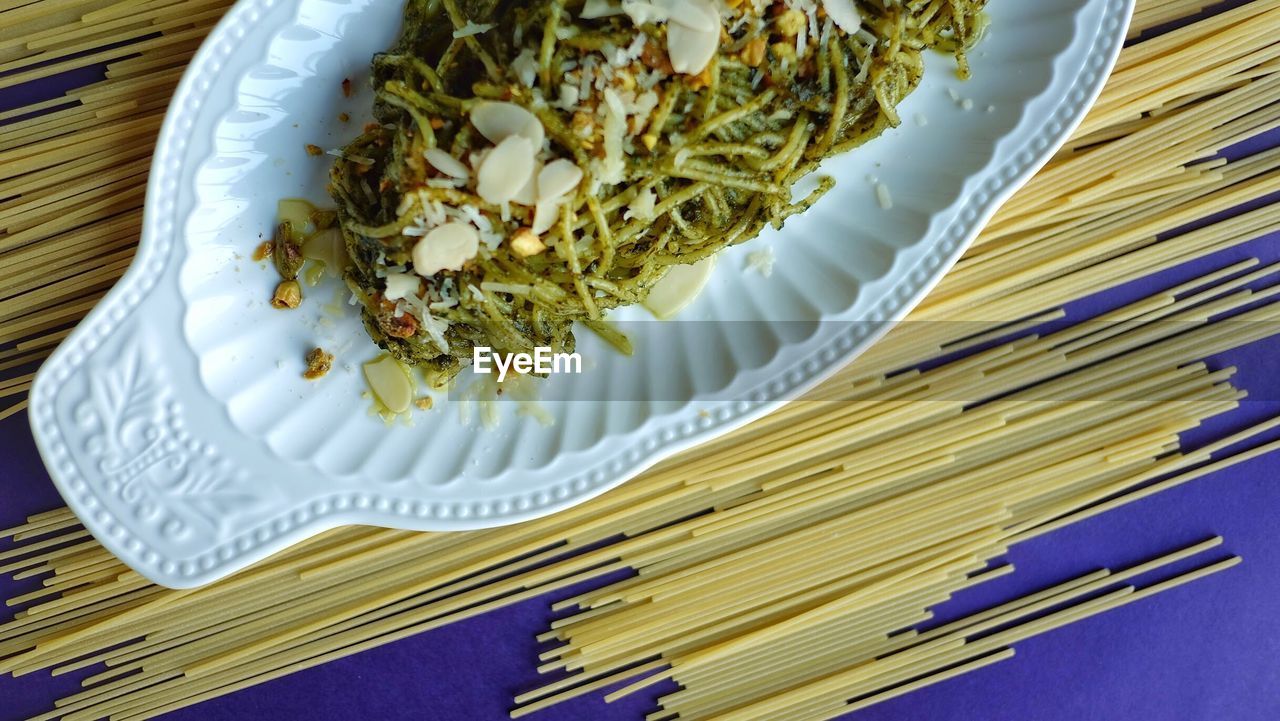 High angle view of food in tray by spaghetti on table