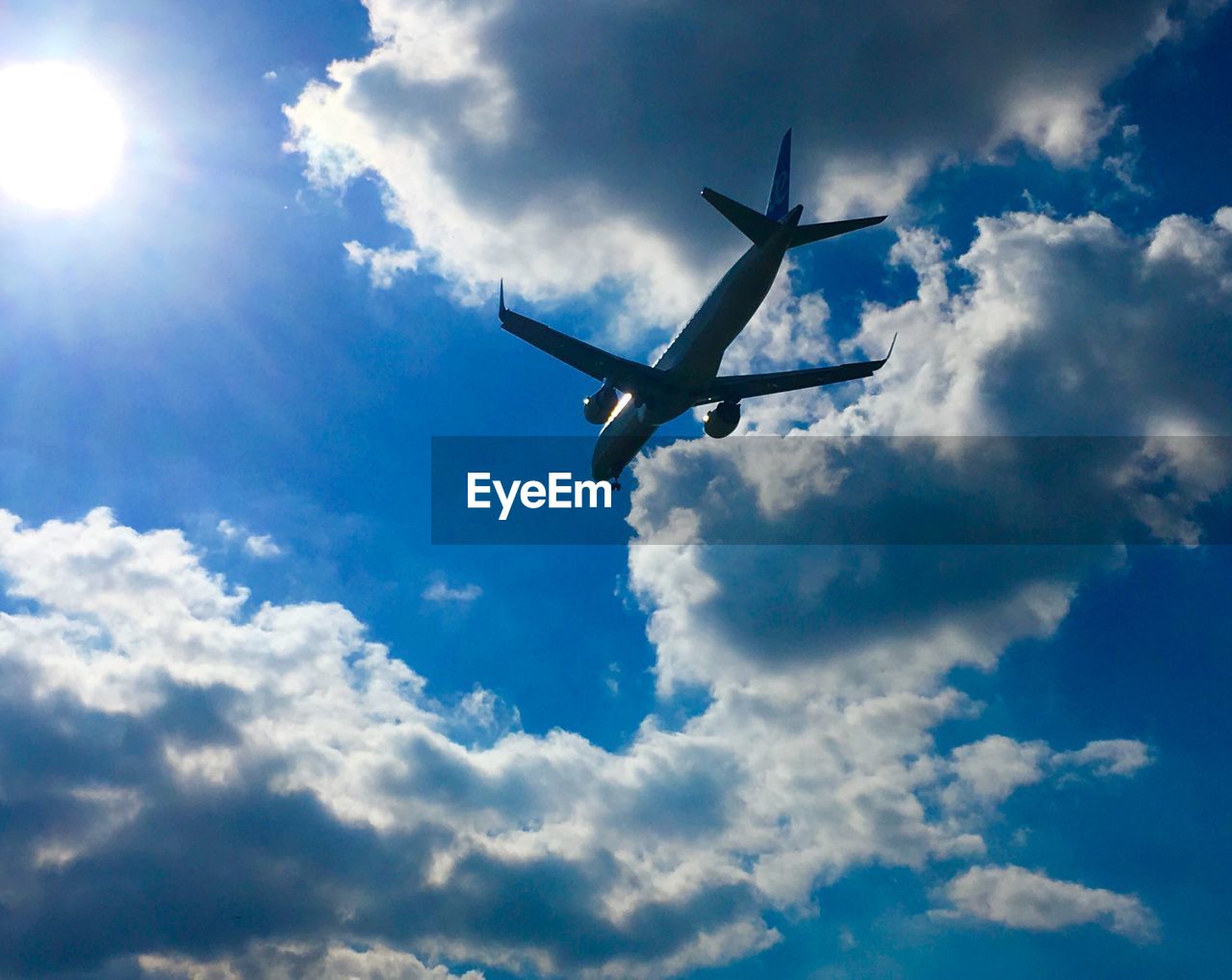 LOW ANGLE VIEW OF AIRPLANE AGAINST SKY