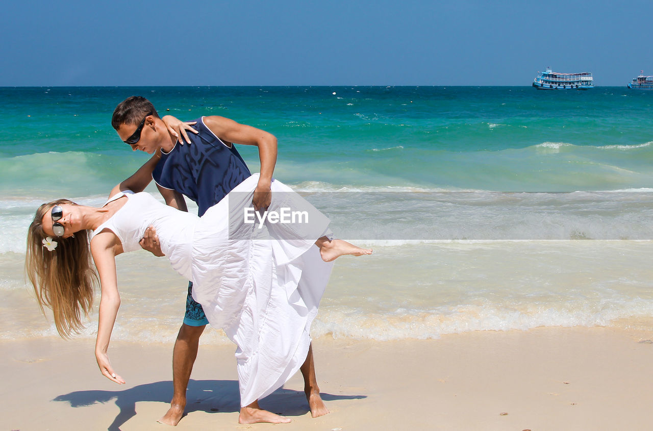 People dancing on sunny beach