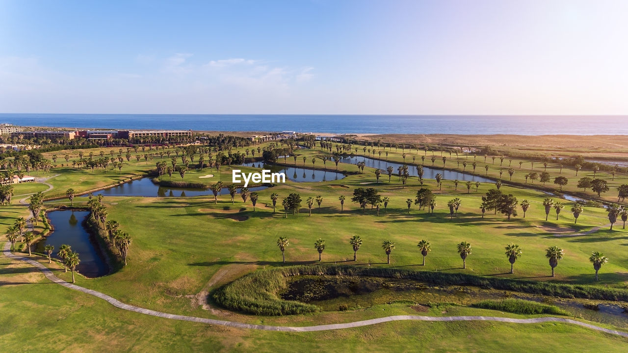 SCENIC VIEW OF SEA AND LANDSCAPE AGAINST SKY