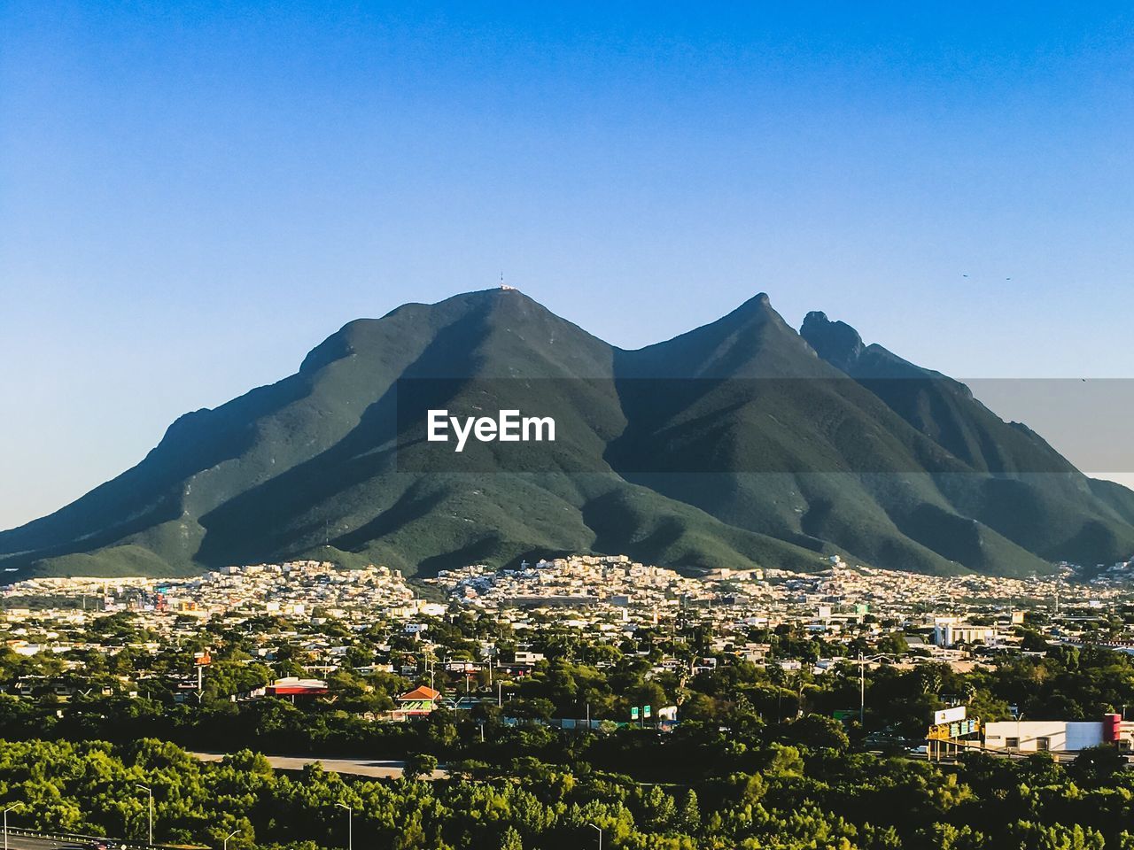 Scenic view of mountains against clear blue sky