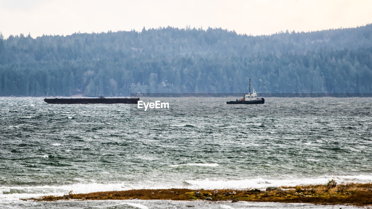 SCENIC VIEW OF SHIP SAILING ON SEA