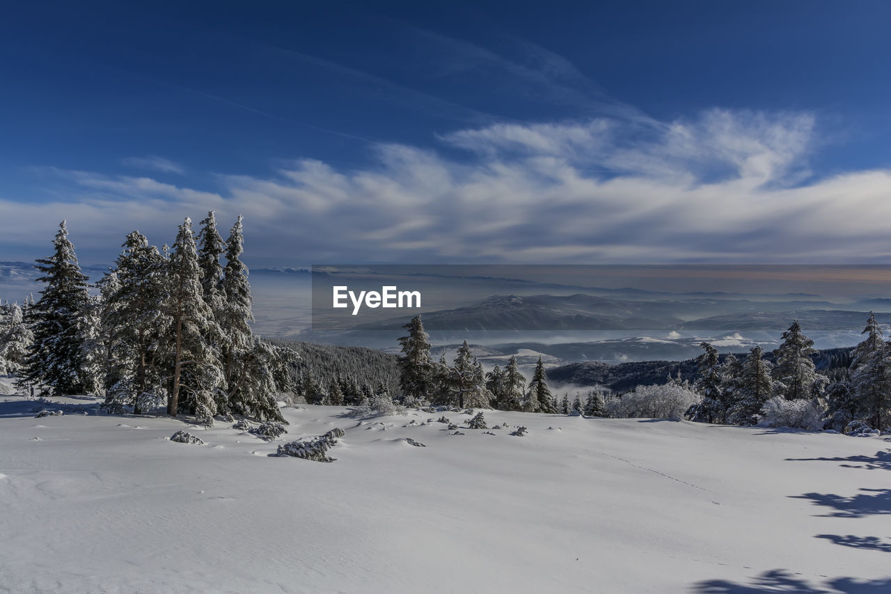 SCENIC VIEW OF SNOW COVERED MOUNTAINS AGAINST SKY