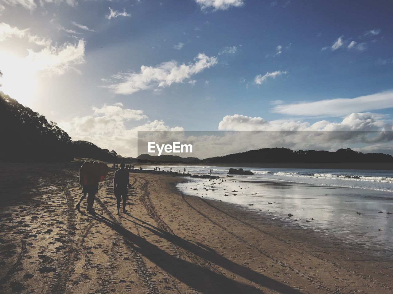 MAN AT BEACH AGAINST SKY