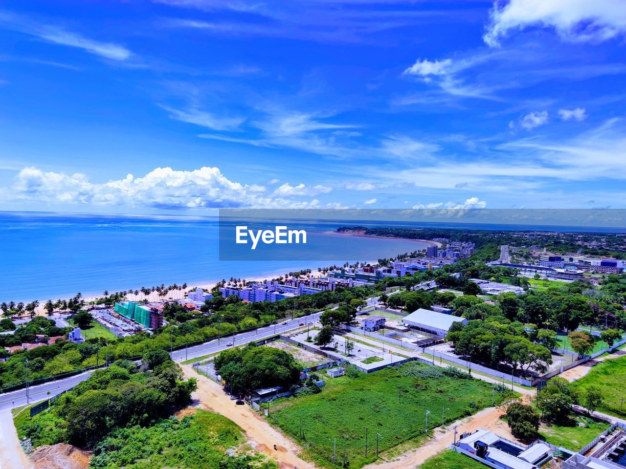 High angle view of buildings and sea against sky