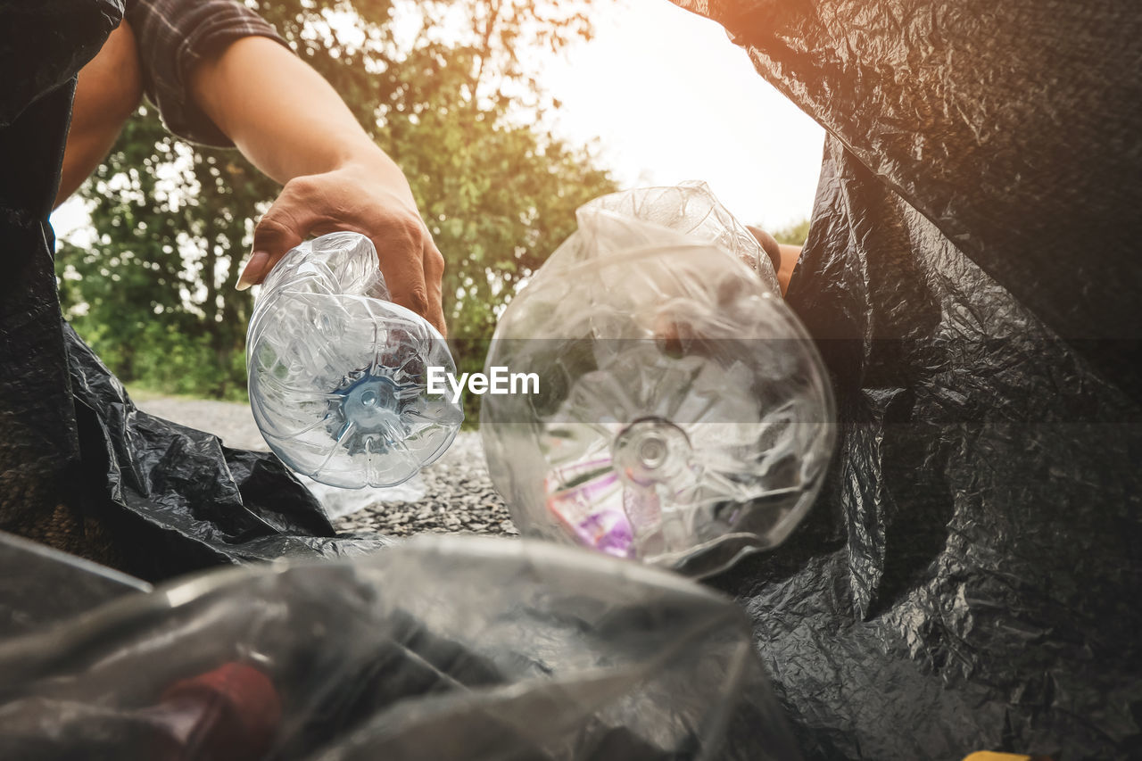 Cropped image of person collecting garbage