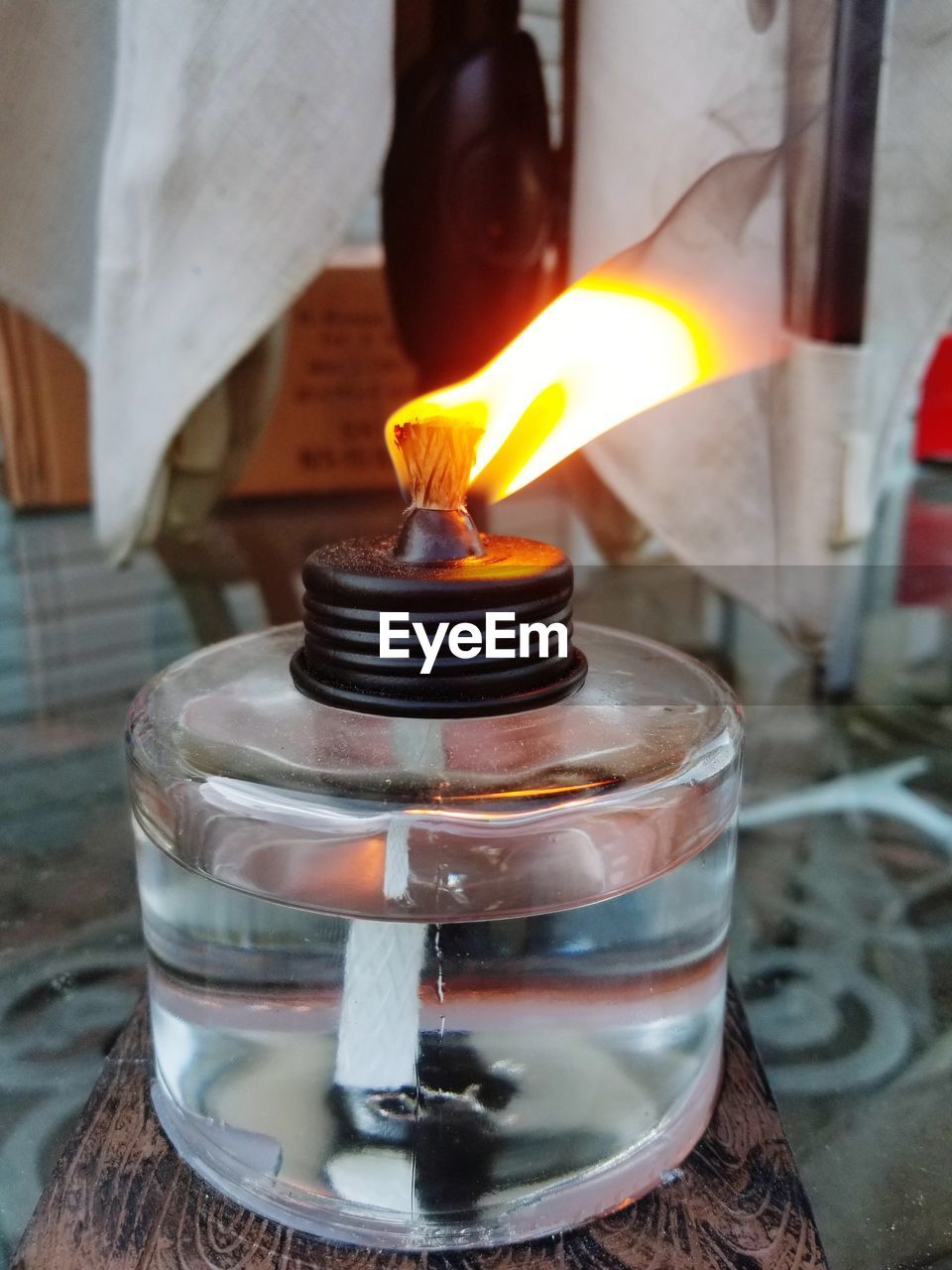 Close-up of lit lamp on table