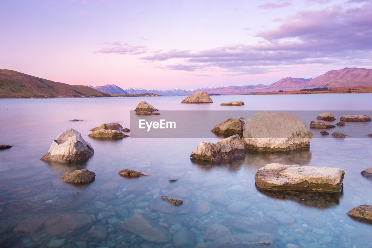 Scenic view of lake against cloudy sky