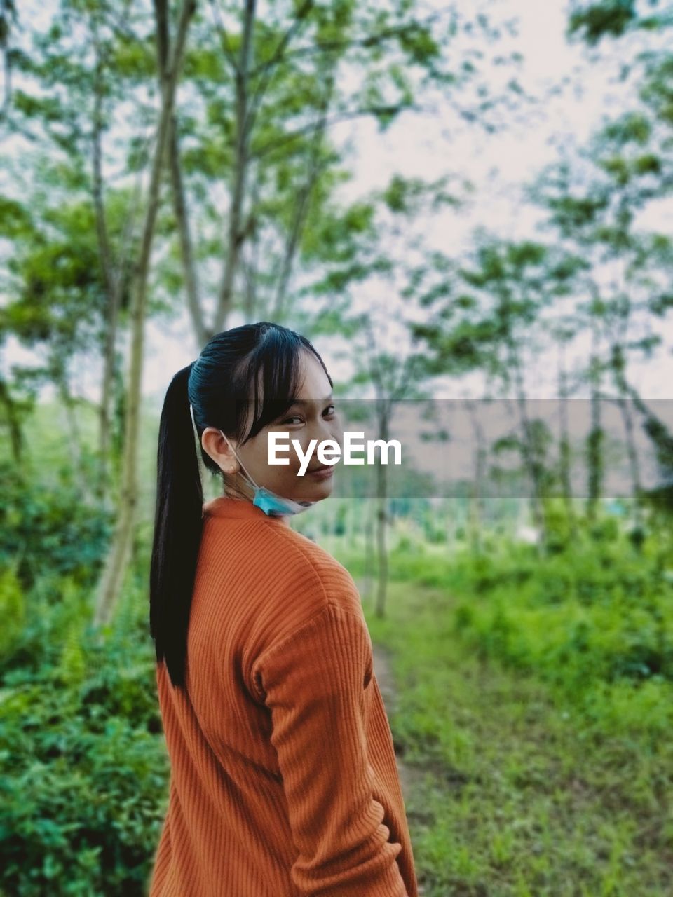 Side view of woman standing on field