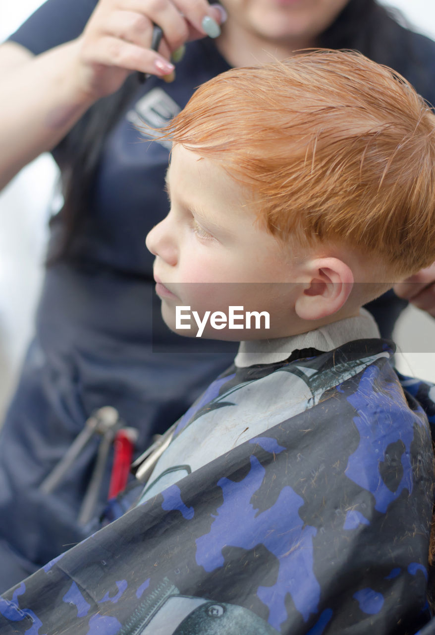 Redhead 4 year old boy in a barbershop