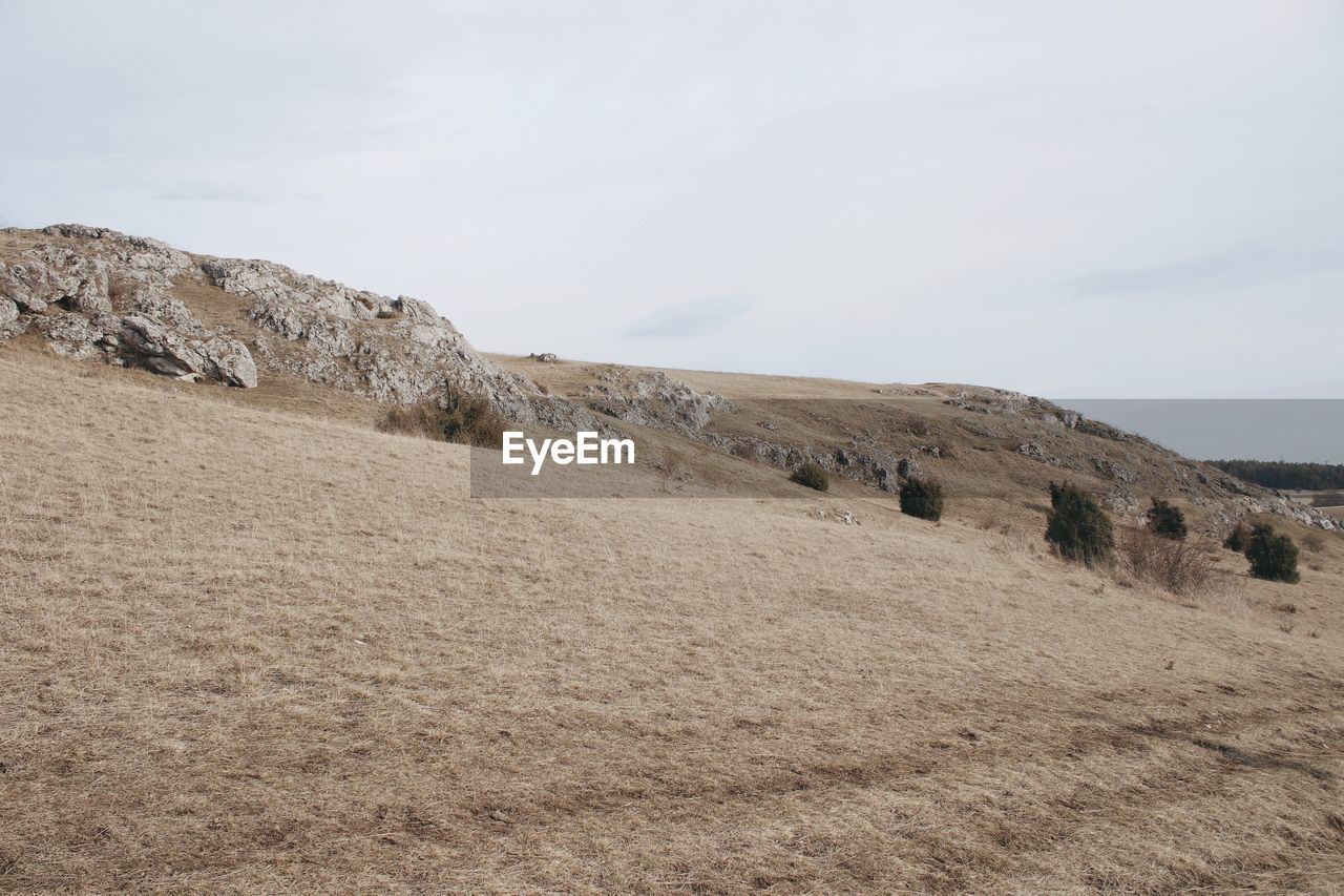 Scenic view of hill against sky