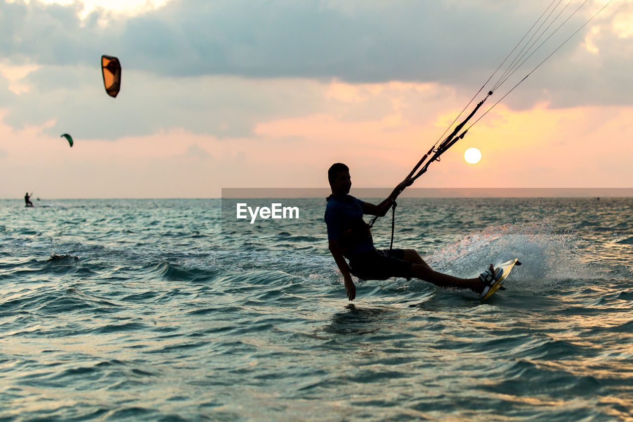 Kitesurfing, kiteboarding in exotic location, tropical island. kitesurfer activities.