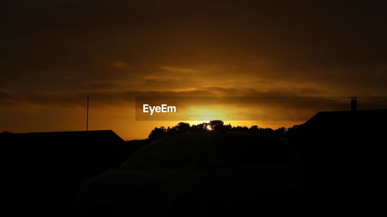 SILHOUETTE OF CAR AGAINST SKY