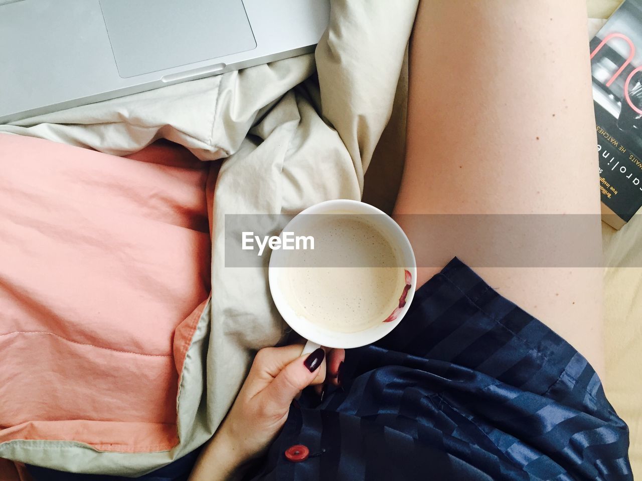 High angle view of woman holding coffee cup