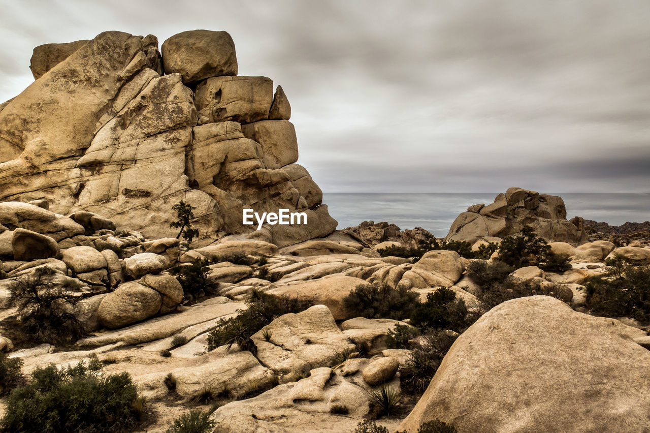 Low angle view of rock formations against sky