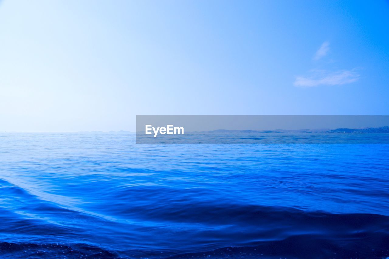 Scenic view of sea against clear blue sky