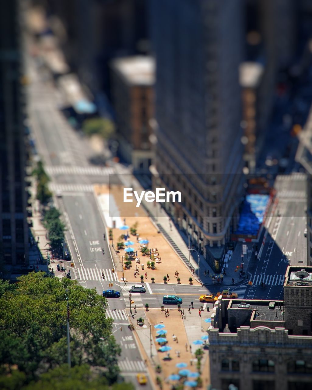 High angle tiltshift view of city street and flatiron building