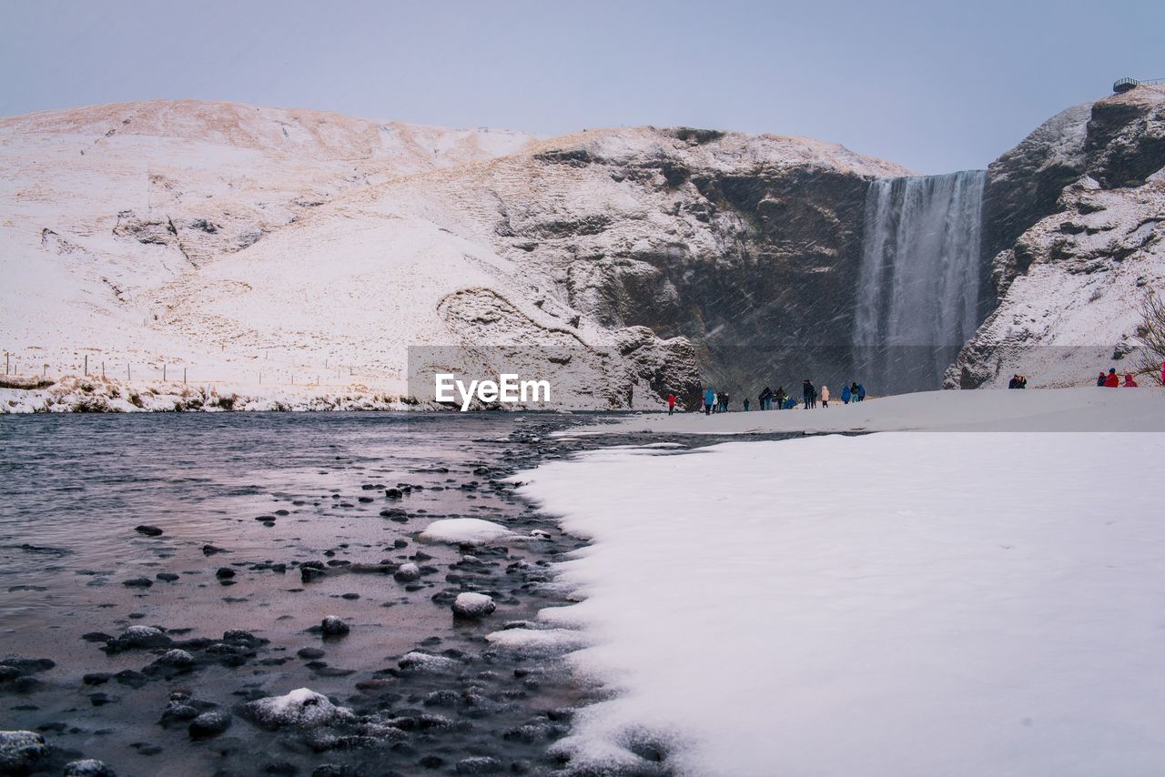 SCENIC VIEW OF FROZEN MOUNTAINS AGAINST CLEAR SKY