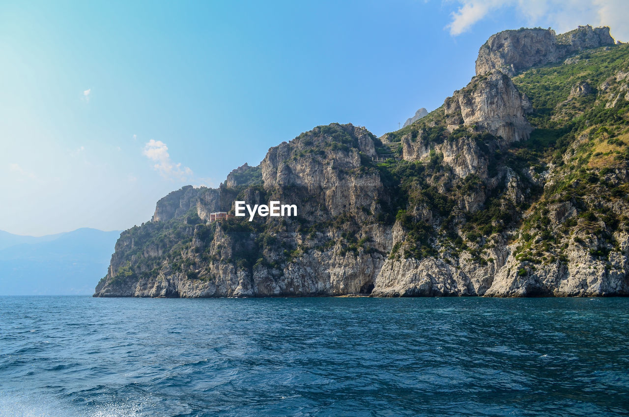 Scenic view of rock formation in sea against sky