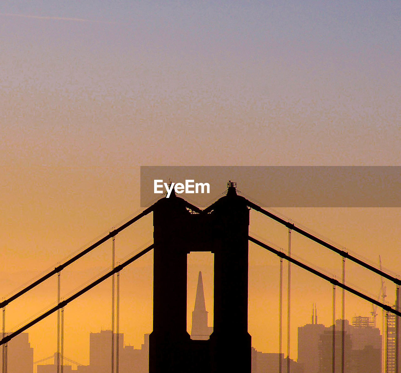 LOW ANGLE VIEW OF SUSPENSION BRIDGE AGAINST CLEAR SKY