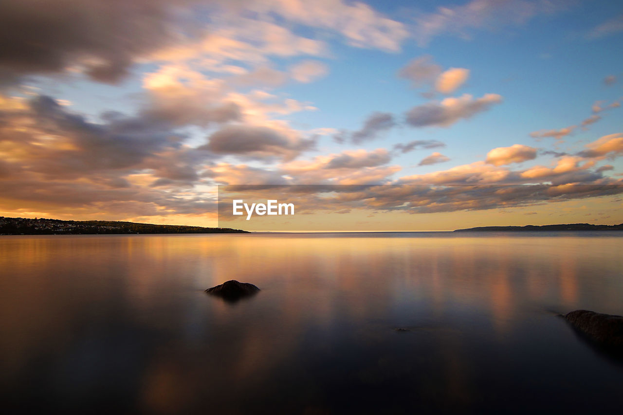 Scenic view of lake against sky during sunset