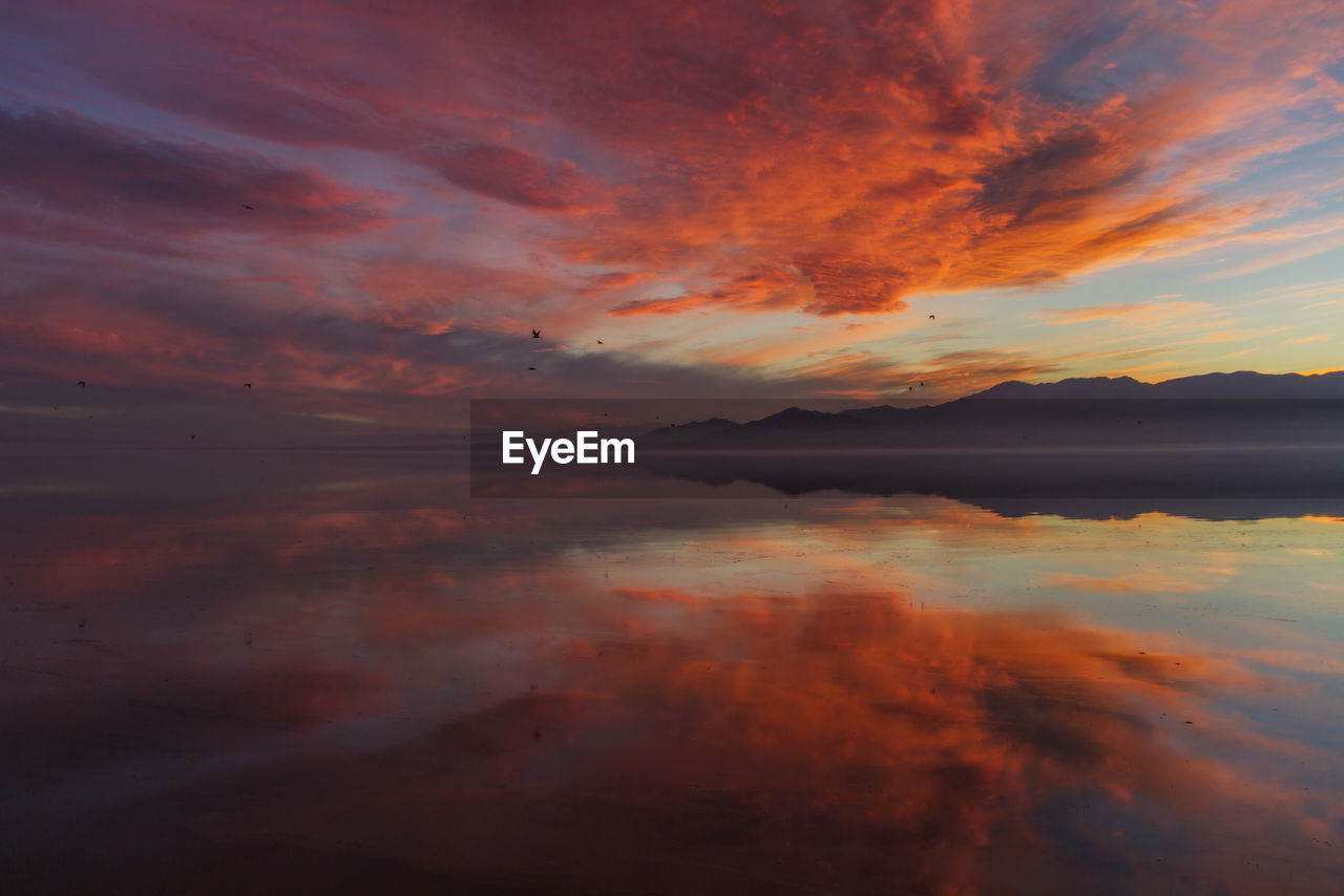 Scenic view of lake against sky during sunset