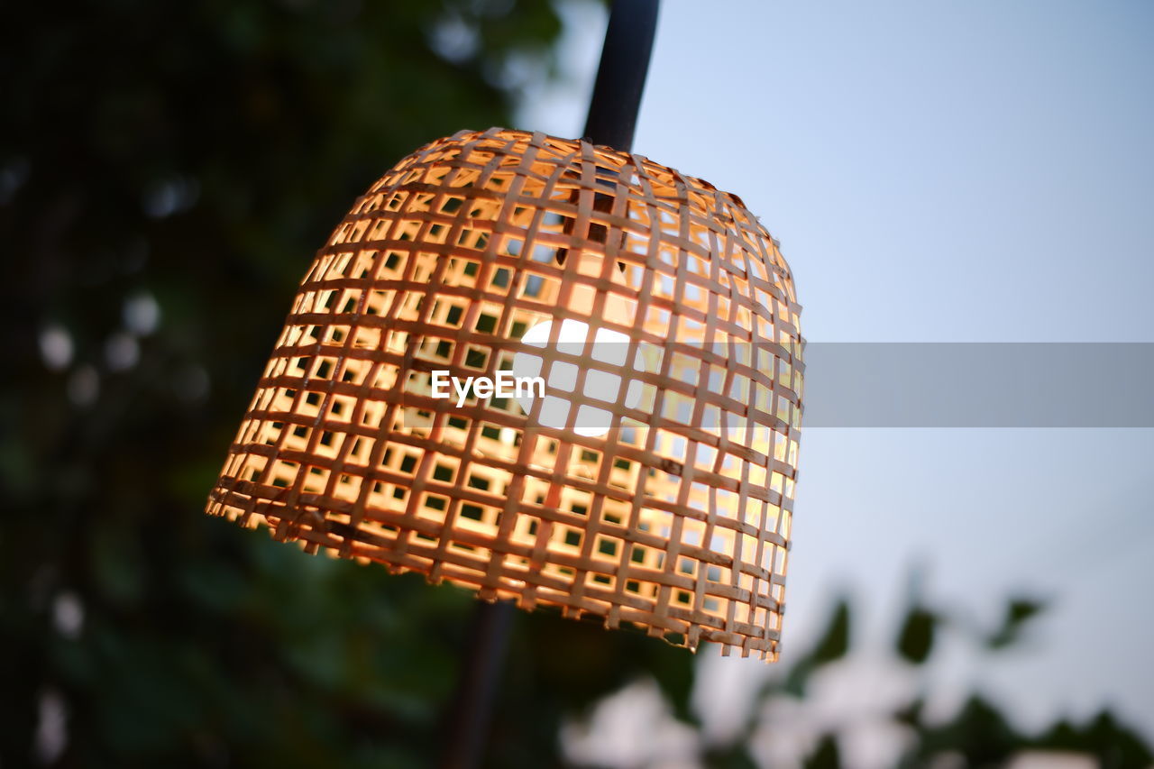 Low angle view of illuminated lamp against sky