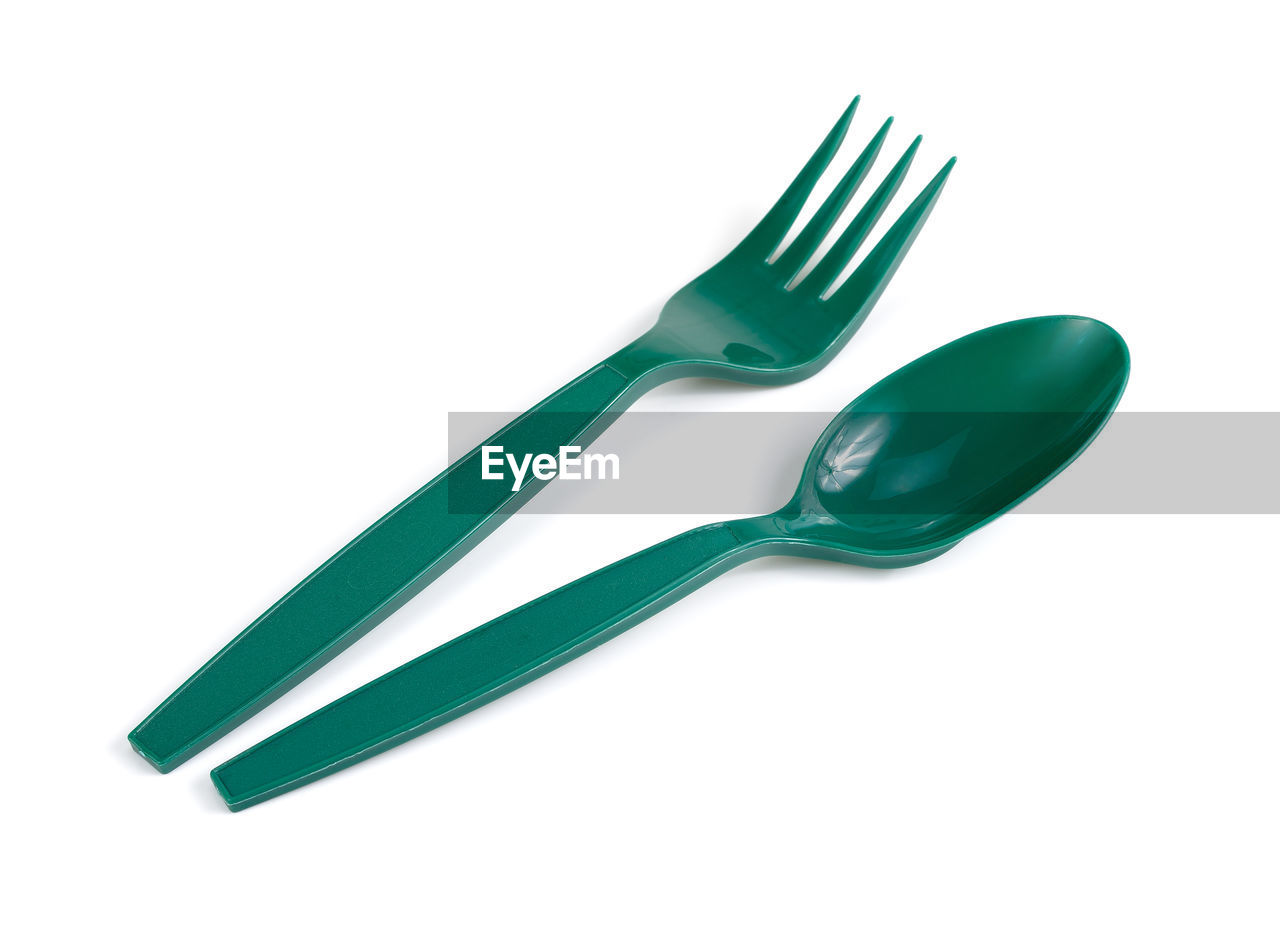 High angle view of fork with spoon on white background