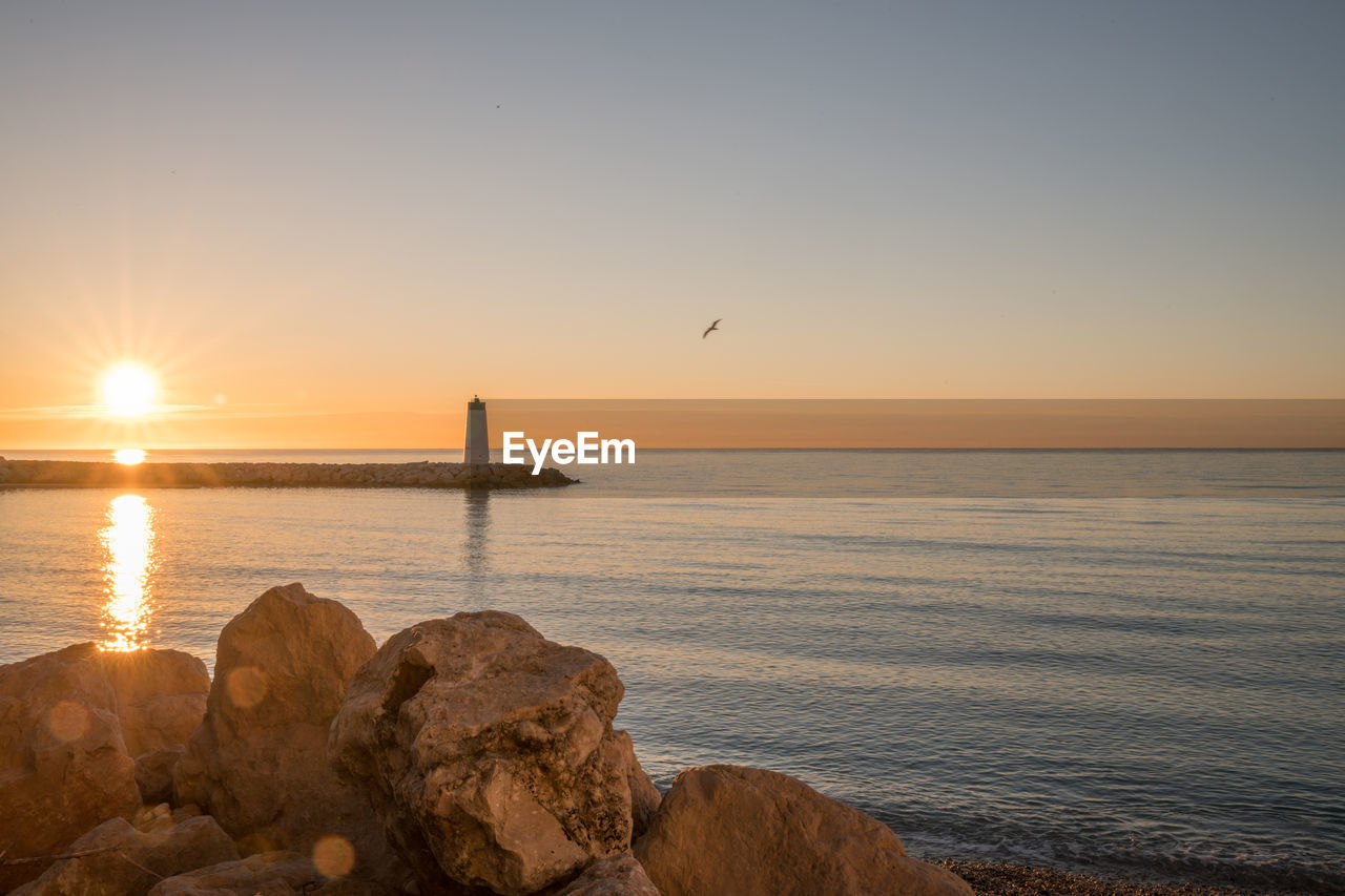 SCENIC VIEW OF SEA DURING SUNSET