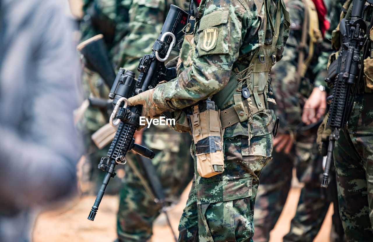 Soldiers with weapons on military combat training