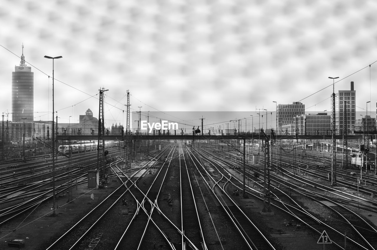 View of railway tracks against sky seen though window