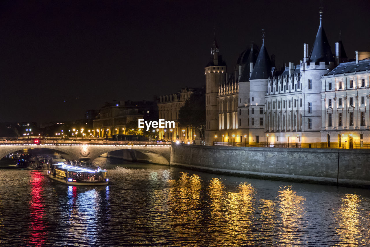 The seine river and the conciergerie illuminated at night