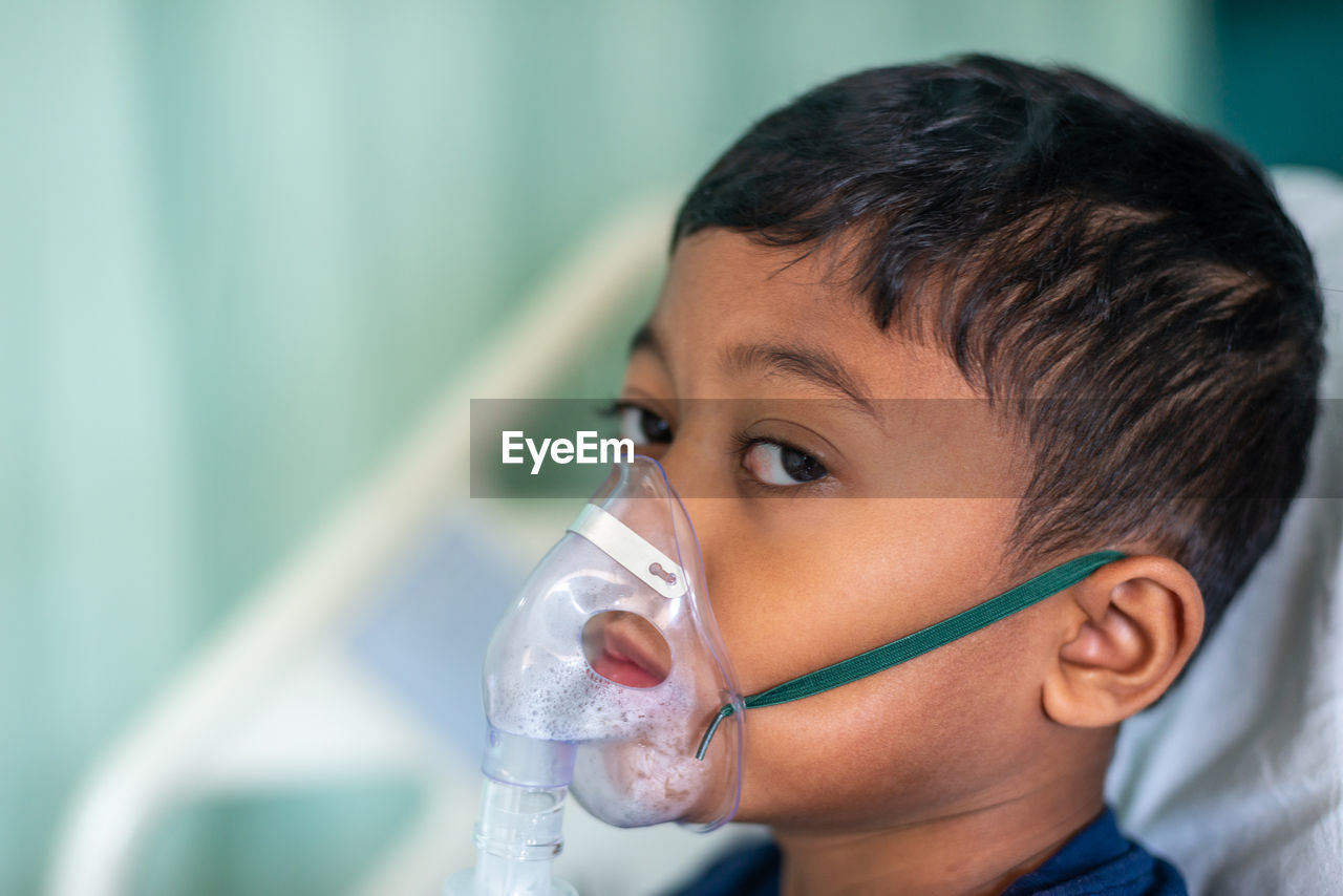 Boy wearing nebulizer at hospital