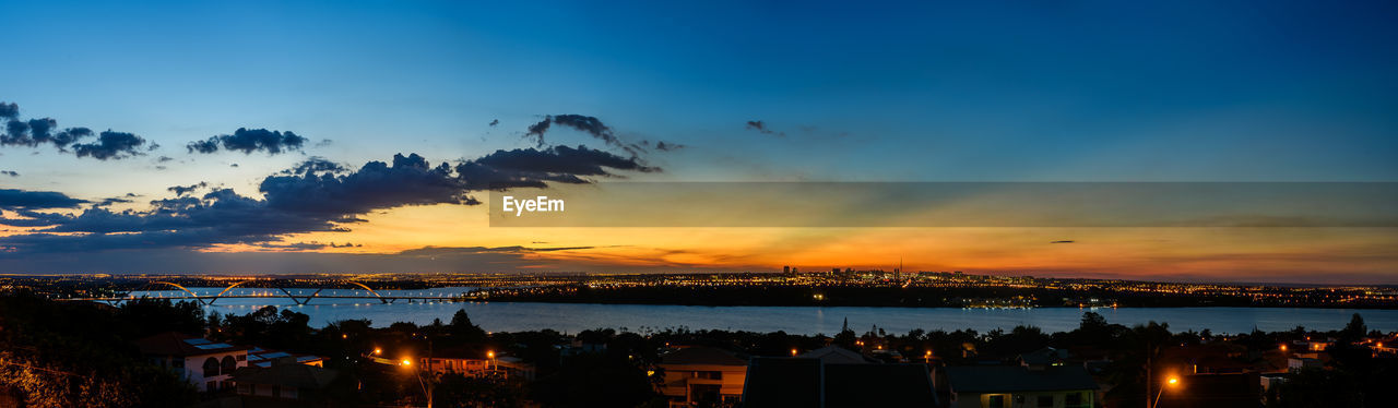 ILLUMINATED CITY AGAINST SKY DURING SUNSET