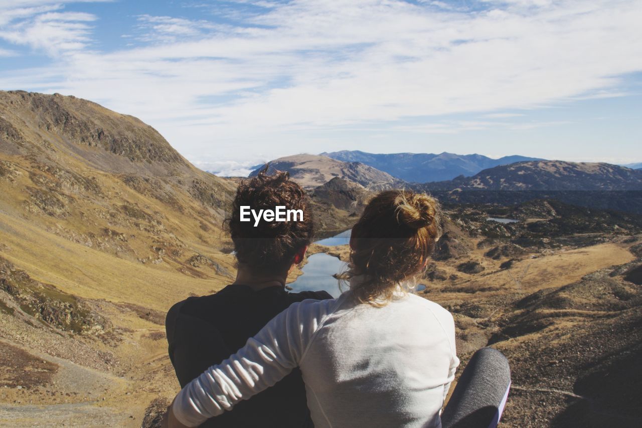 Rear view of friends looking at mountains