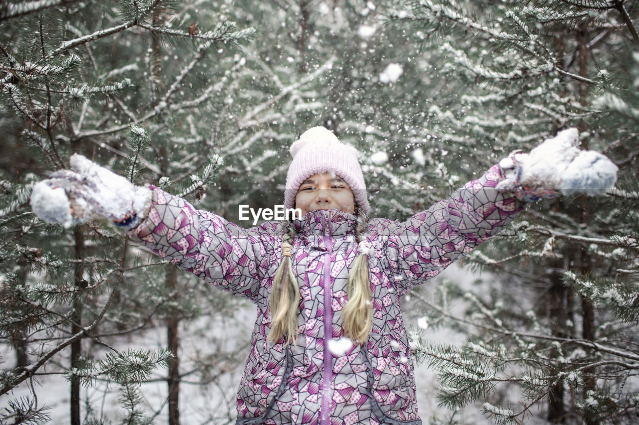 Portrait of cute girl standing outdoors in winter