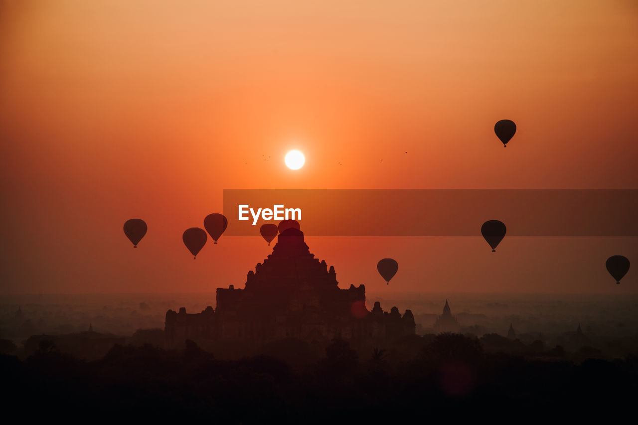 SILHOUETTE OF HOT AIR BALLOONS IN SKY DURING SUNSET