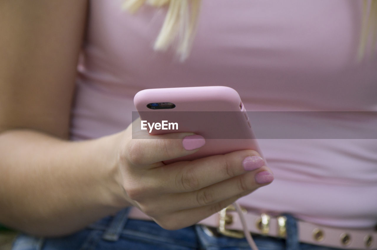 Midsection of woman using phone