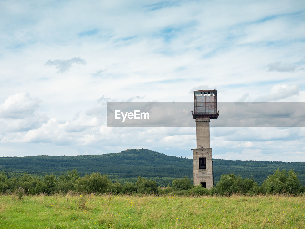 Mine tower and abandoned residues from iron and copper ore mining under medenec hill.  north czechia