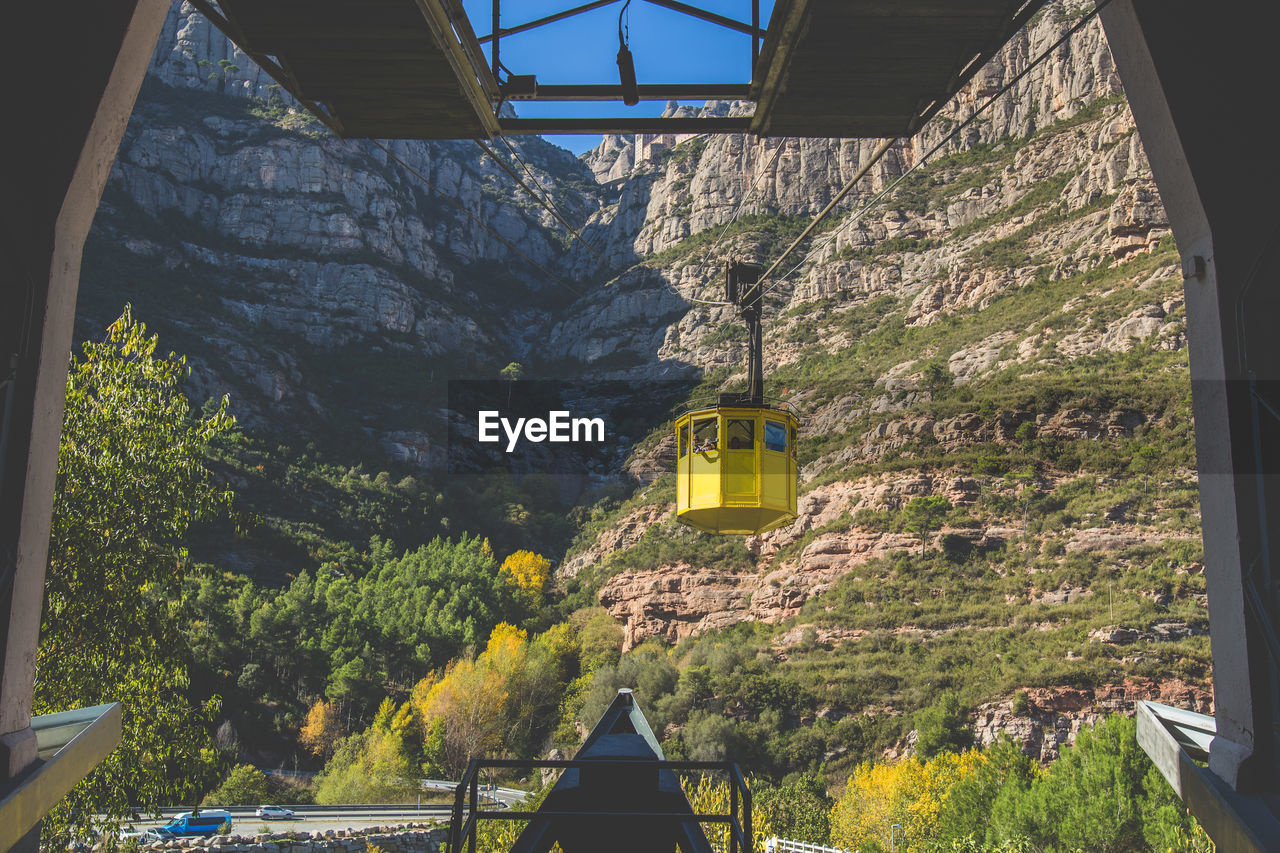 Overhead cable car against rocky mountain