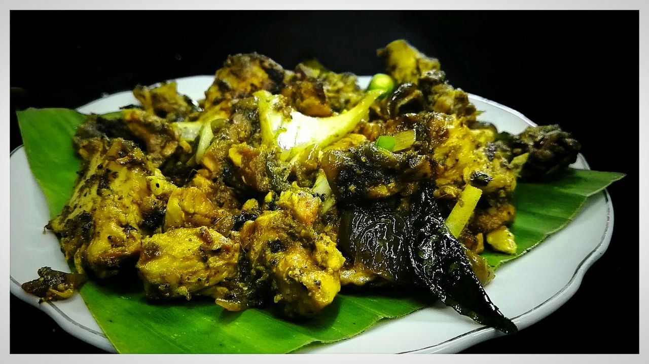 Close-up of chicken on banana leaf