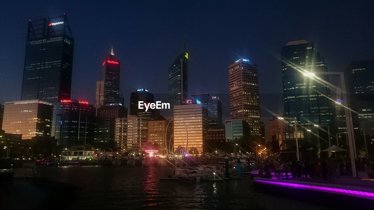 Skyscrapers at waterfront lit up at night at elizabeth quay