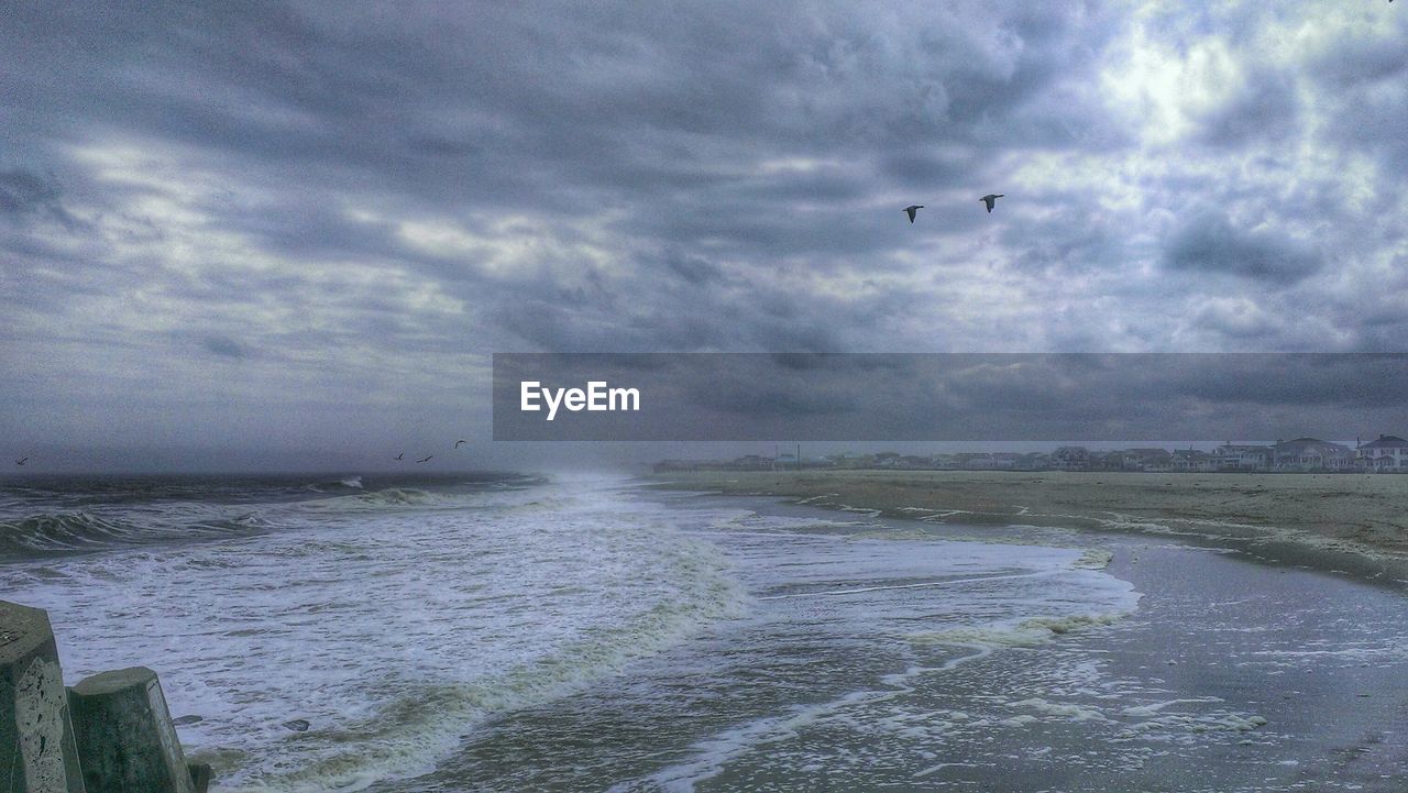 View of calm sea against clouds